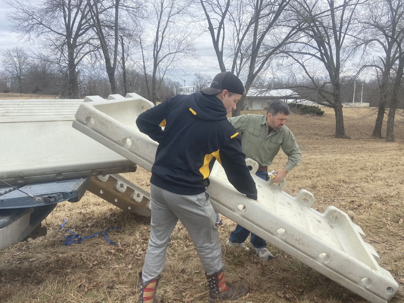 Community members unload new boards for rink